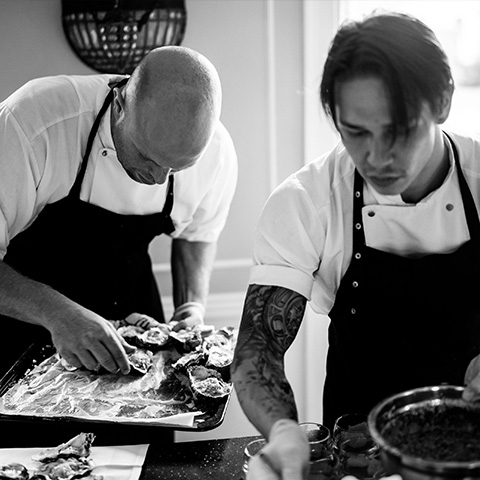 Chefs prepare seafood in italian restaurant Mondello